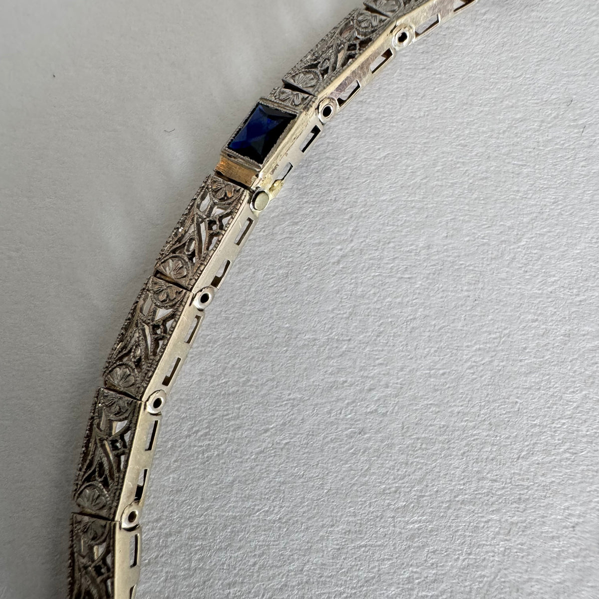 14K gold bracelet featuring intricate openwork and beautifully engraved details set with Sapphire & Diamonds