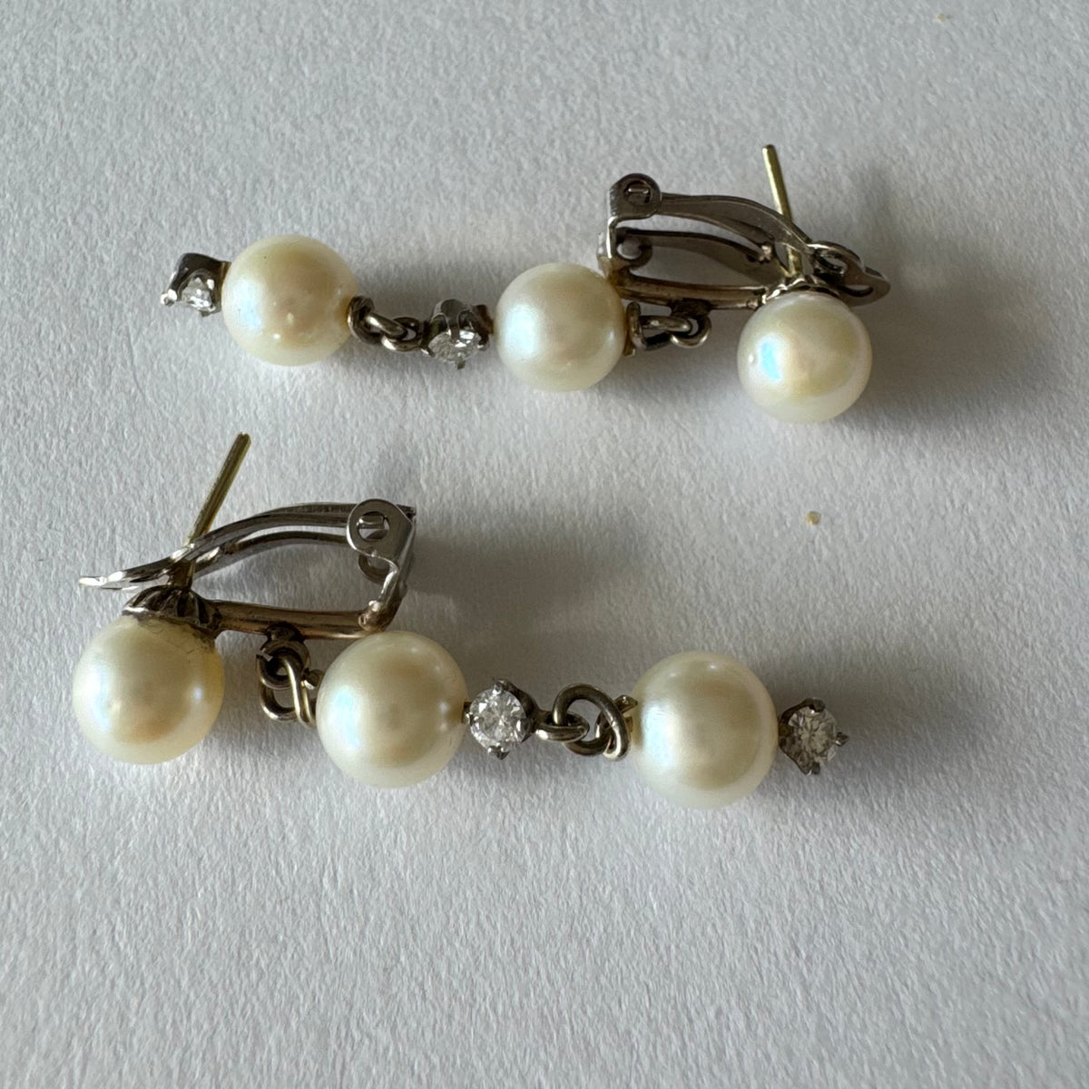 14K gold elegant drop earring set with three soft creamy Pearls connected by round brilliant Diamonds