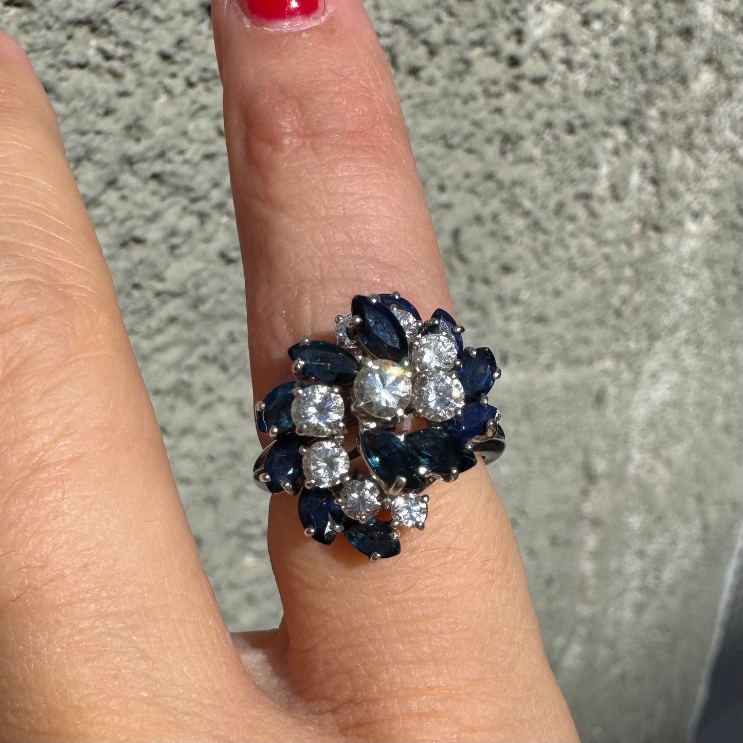 18K white gold ring, set with marquise-cut blue Sapphires and round Diamonds, in a classic cluster design.