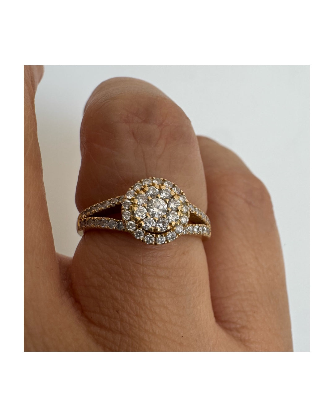 14K gold ring set with Diamonds in a sparkling halo design.