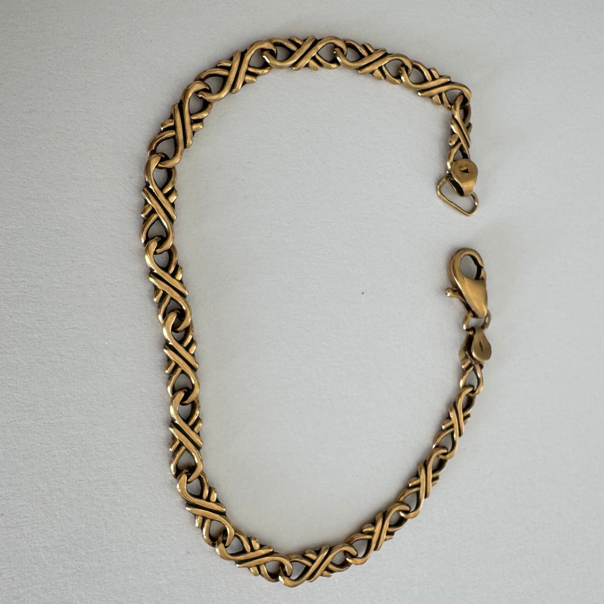 14K gold bracelet with a delicate twisted-link design.