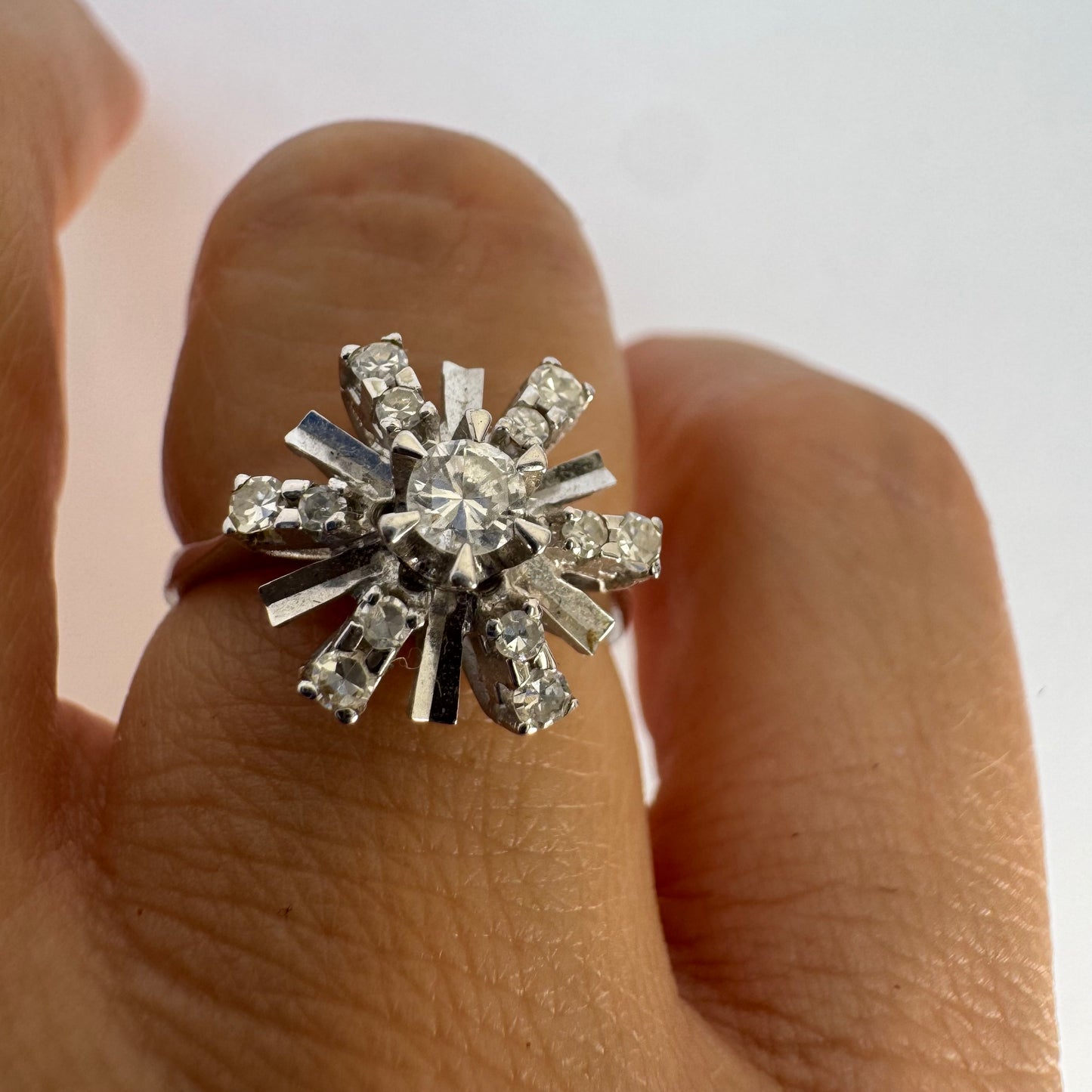 18K white gold ring designed as a radiant starburst, set with brilliant-cut diamonds that capture the light from every direction