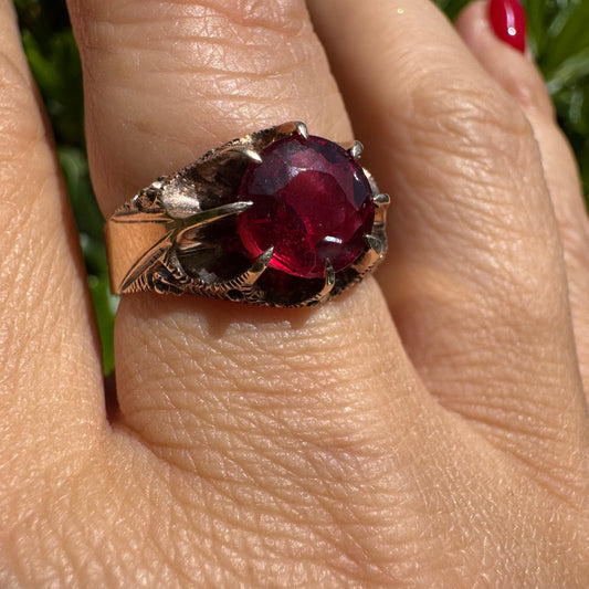 10K gold ring set with a bold deep-red gemstone