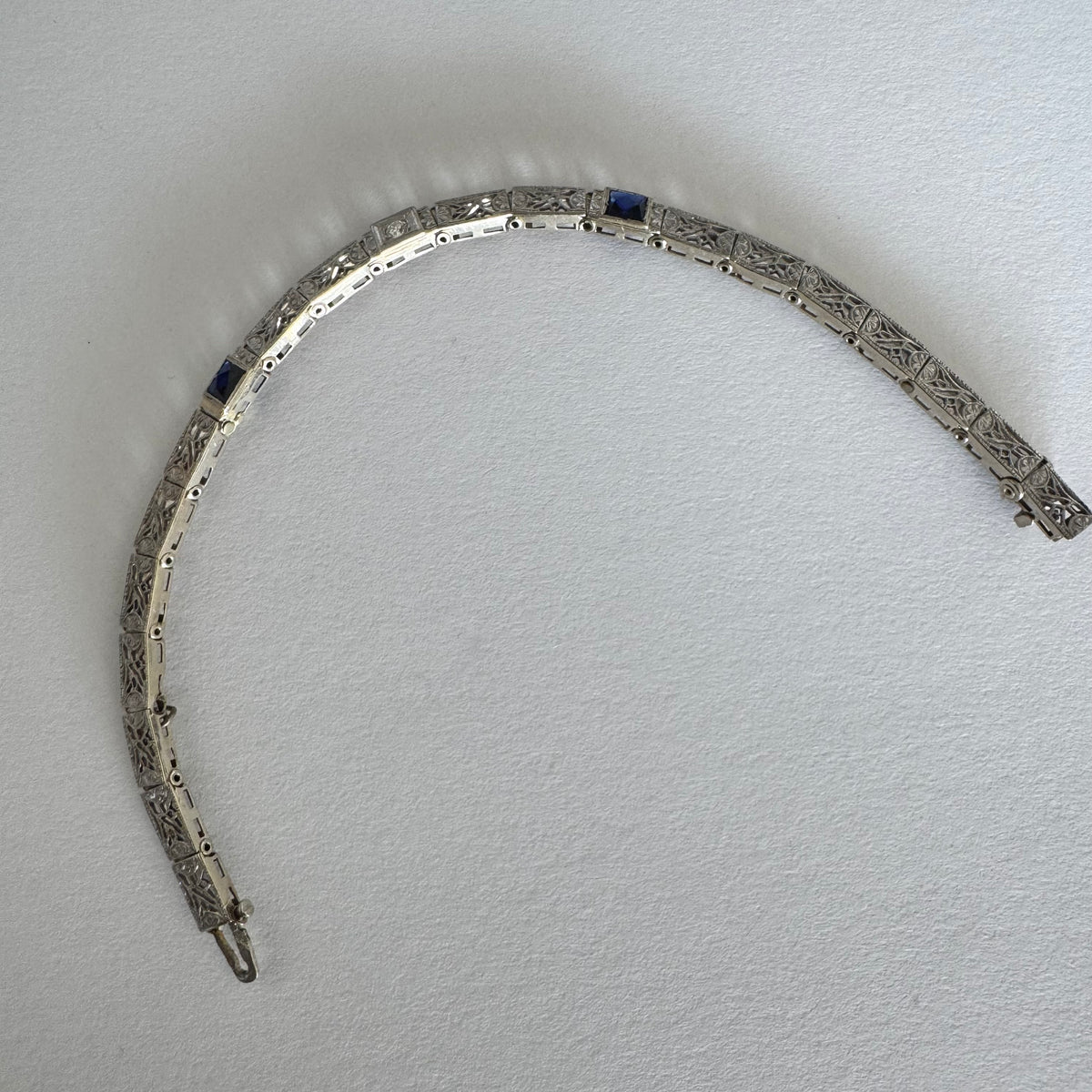 14K gold bracelet featuring intricate openwork and beautifully engraved details set with Sapphire & Diamonds