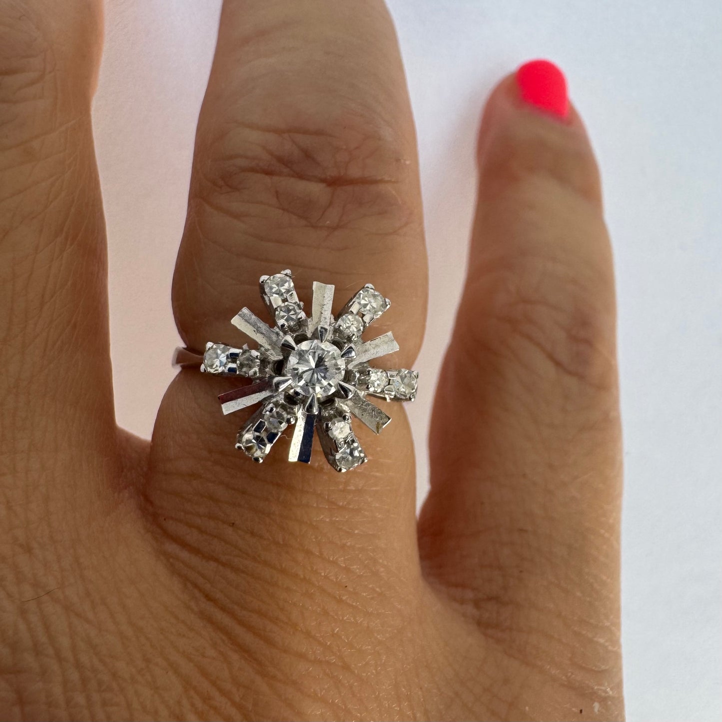 18K white gold ring designed as a radiant starburst, set with brilliant-cut diamonds that capture the light from every direction