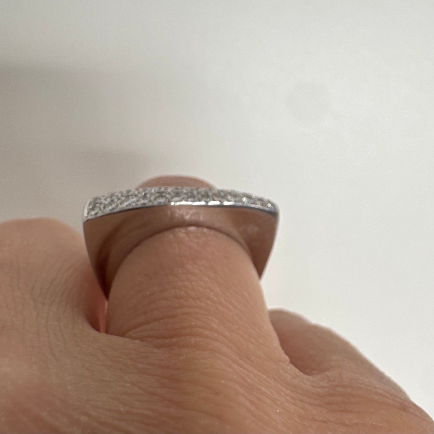18K white gold band fully set with pavé diamonds across the surface.