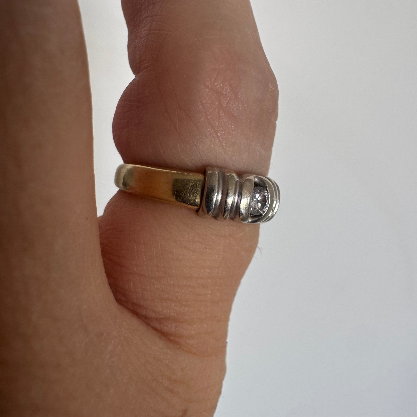 14K two-tone gold ring set with a central Diamond in a clean and refined design