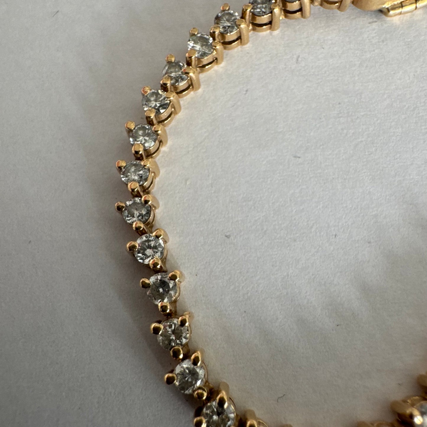 14K gold tennis bracelet set with a continuous line of round Diamonds, creating a delicate and elegant sparkle.