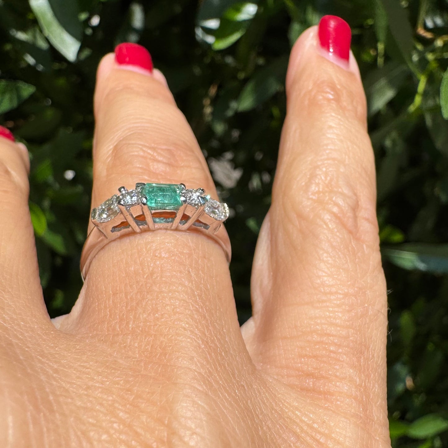 14K gold ring set with one center Emerald & Diamonds on the sides