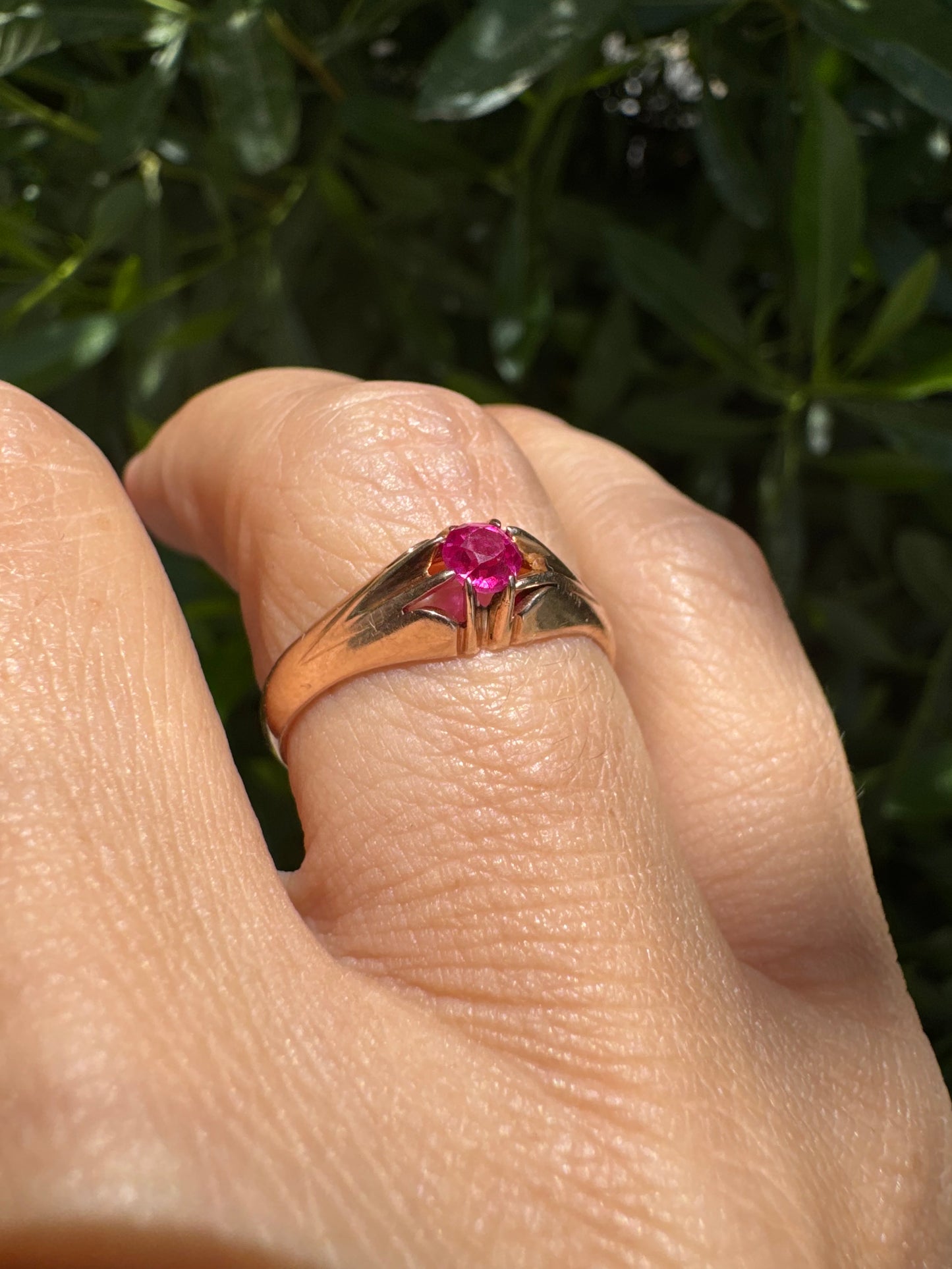 14K gold ring set with a vivid pink round-cut Ruby