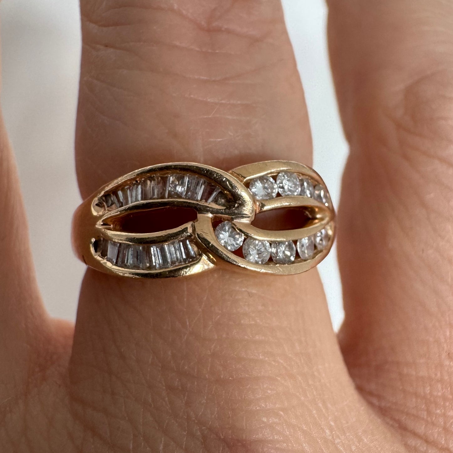 14K gold open infinity ring set with round and baguette-cut Diamonds.