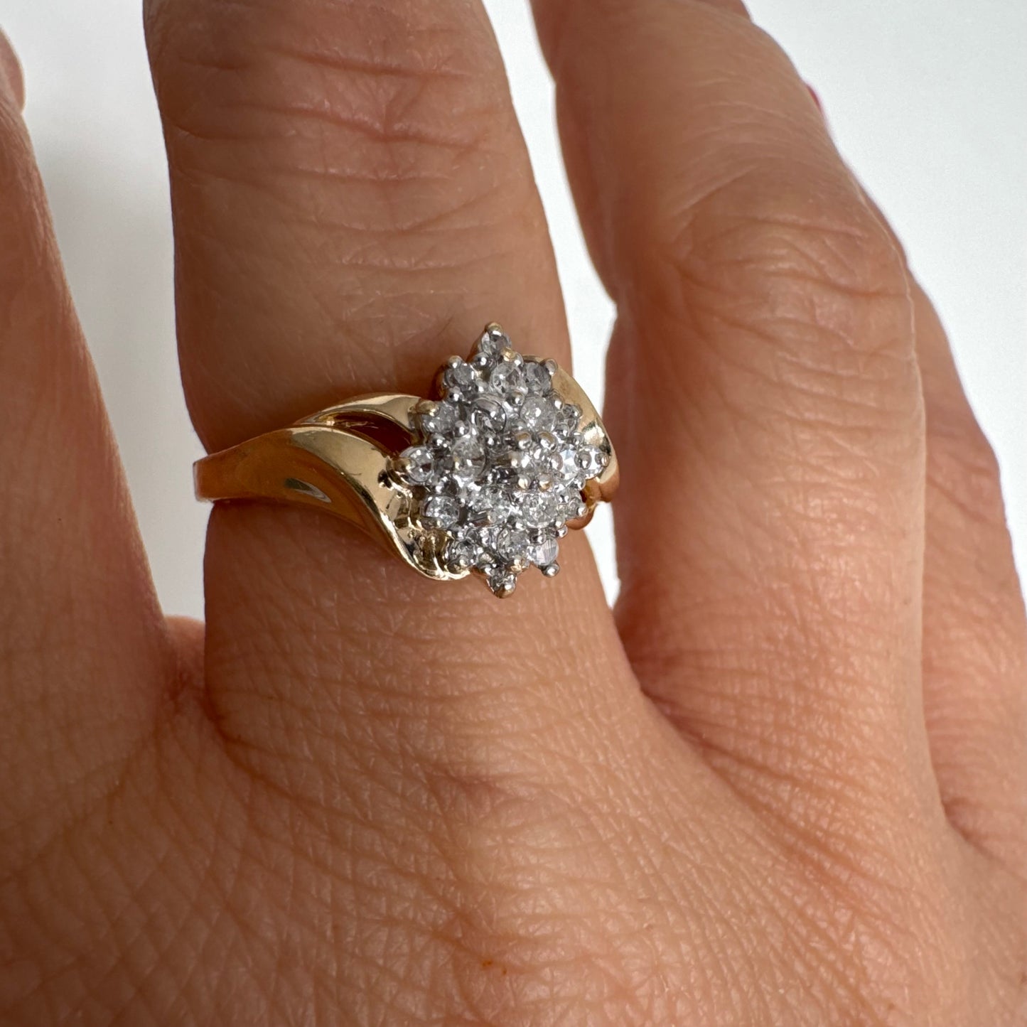 10K gold ring set with Diamonds, featuring a classic design with soft, flowing curves.