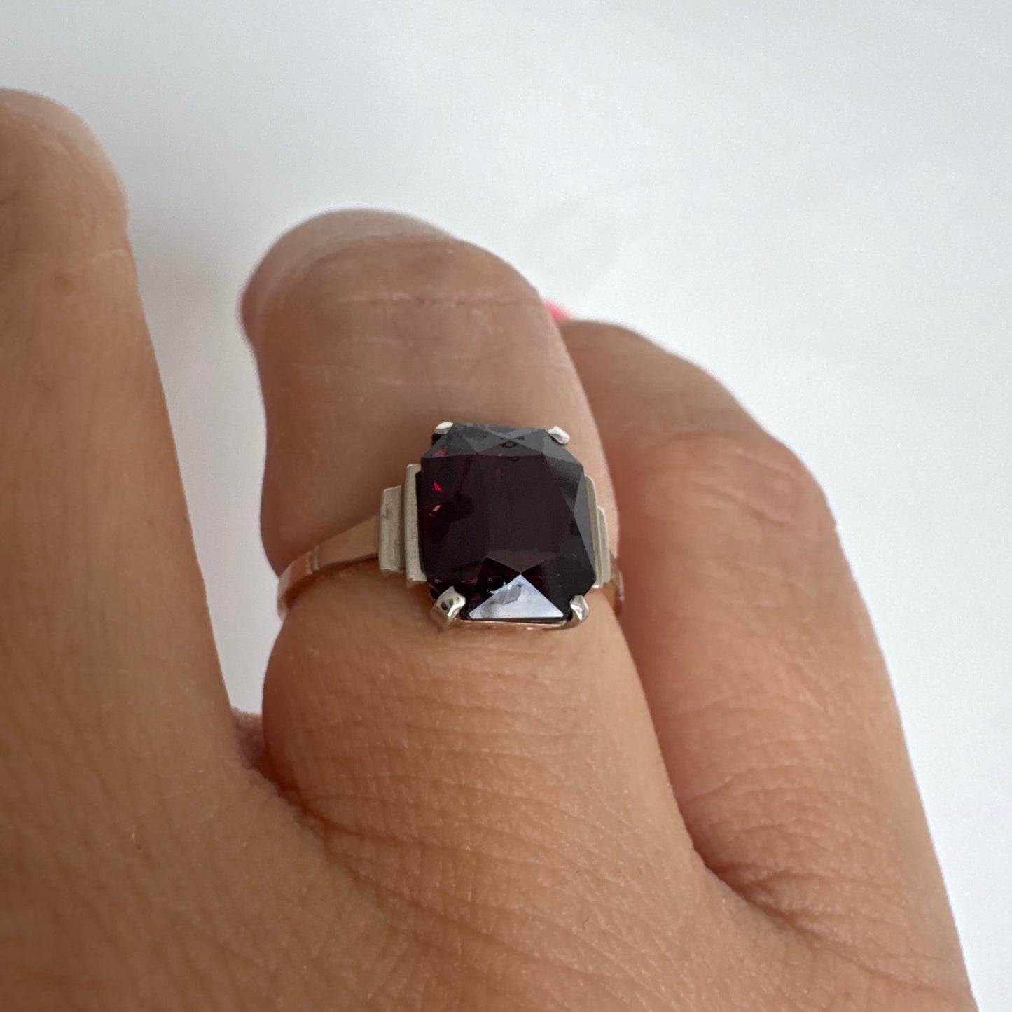 9K gold ring set with a deep burgundy Garnet in an elegant square cut.