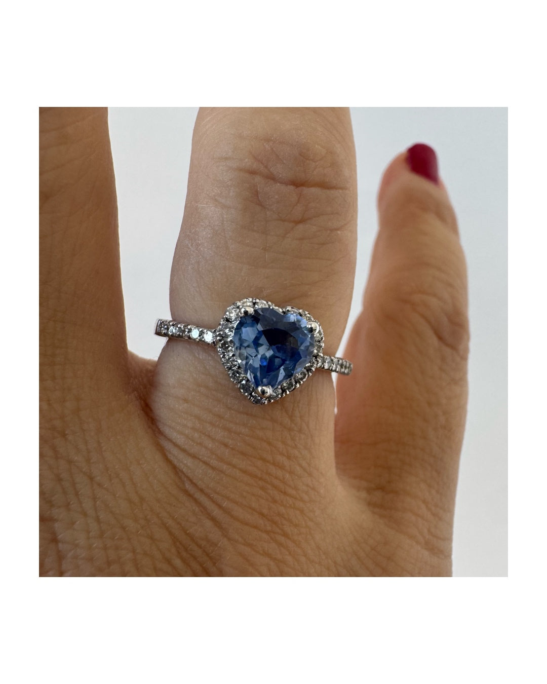 14K gold ring set with a heart-cut Tanzanite surrounded by a halo of Diamonds