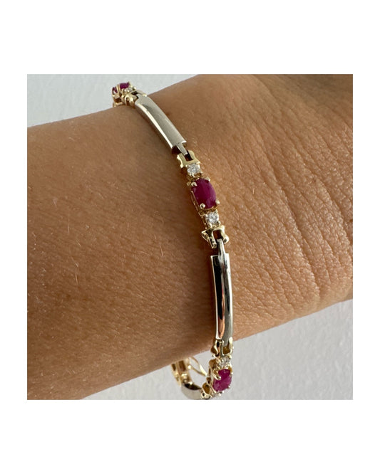 צמיד זהב צהוב 14 קראט משובץ אבני רובי אדומות בחיתוך אובלי, עם יהלומים המשובצים ביניהן להוספת ברק עדין.