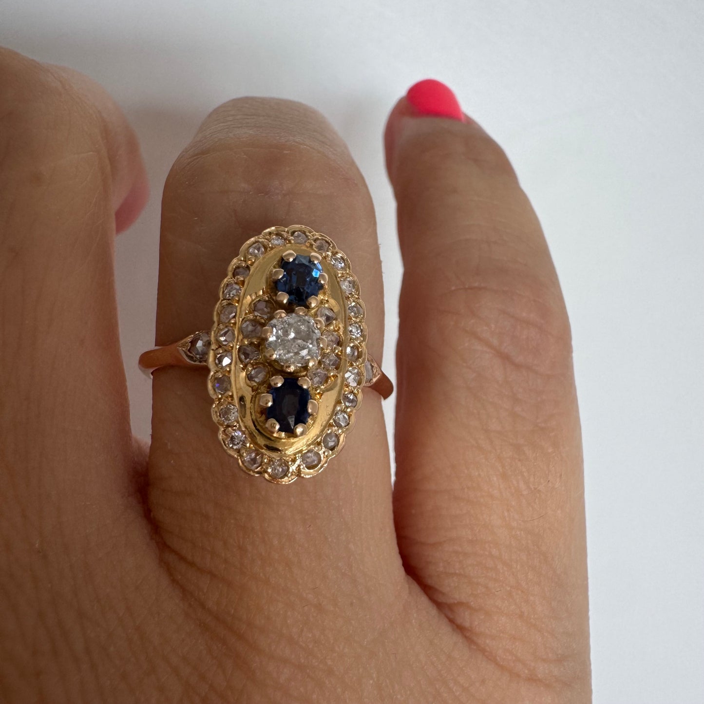 14K gold ring set with Diamonds and deep blue Sapphires in a classic oval design.