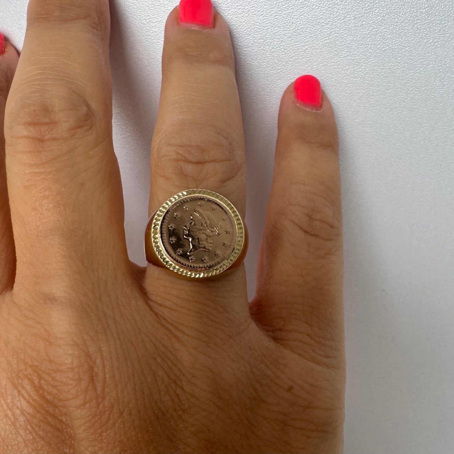 18K gold coin ring set with an authentic 22K gold coin at the center.
