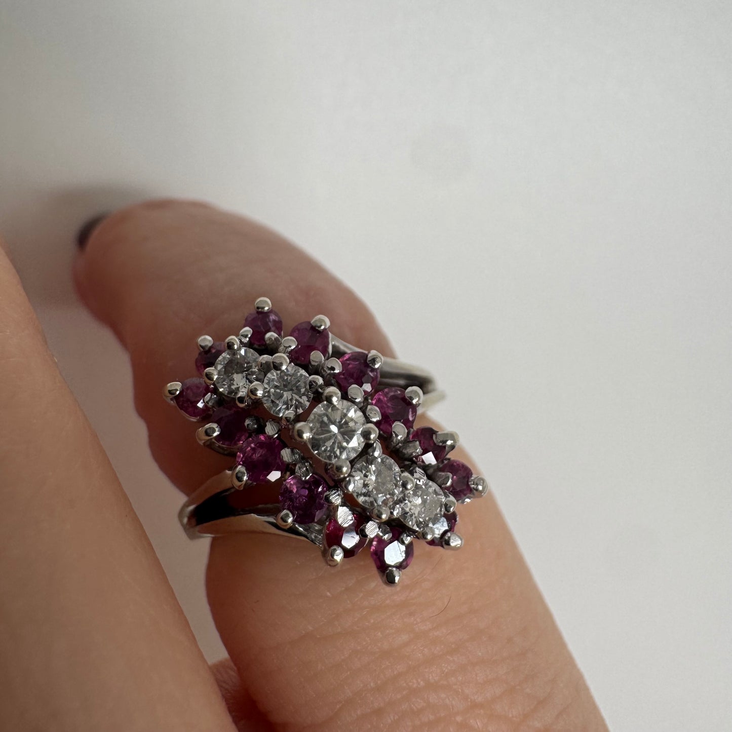 14K gold ring set with a rich cluster of deep raspberry-toned Rubies, centered by a vertical row of sparkling white Diamonds.