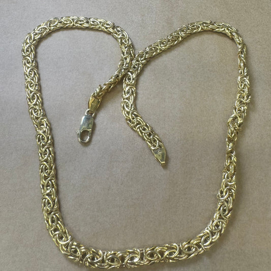 14K yellow gold necklace featuring an intricate, twisted link design
