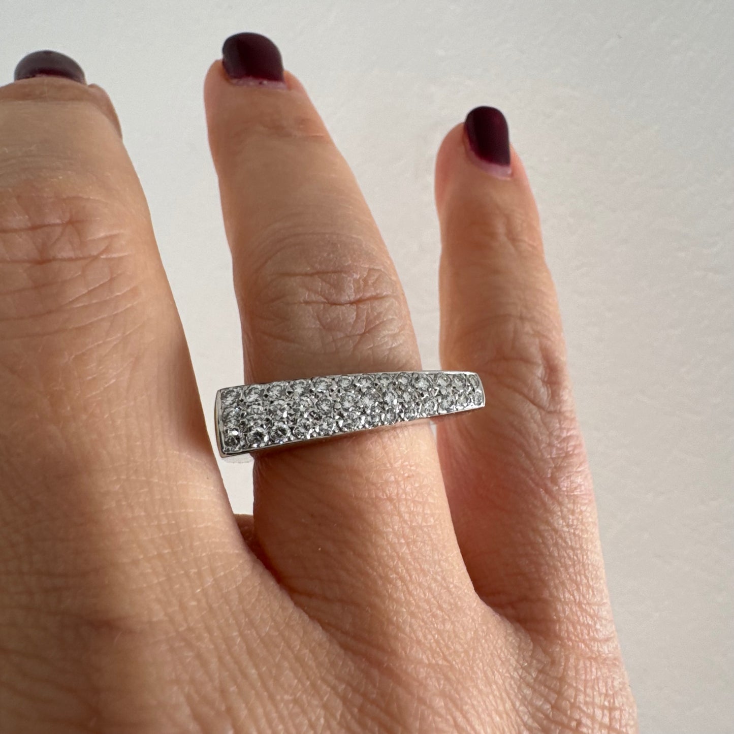 18K white gold band fully set with pavé diamonds across the surface.