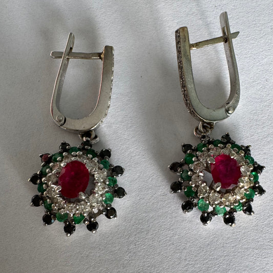 14K white gold drop earrings set with white and black Diamonds, Emeralds and a central Ruby