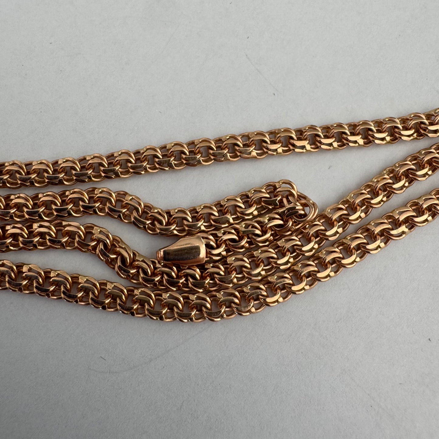 14K gold chain featuring an intricate woven link