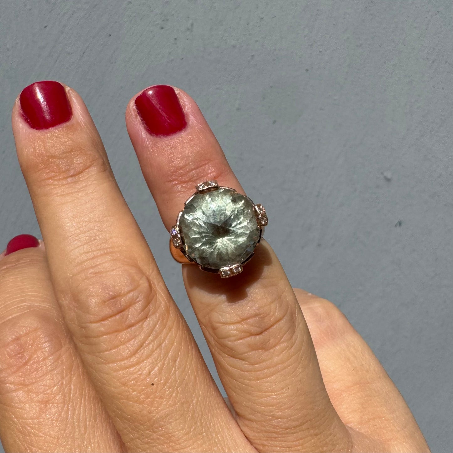 18K gold ring set with a large round Prasiolite gemstone accented by small Diamonds