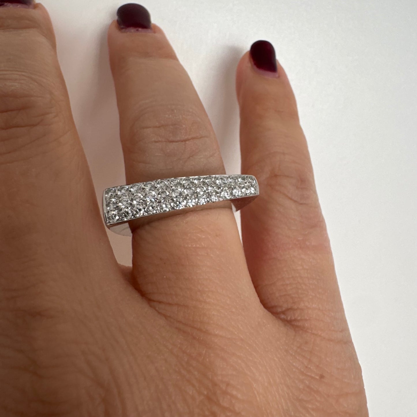 18K white gold band fully set with pavé diamonds across the surface.
