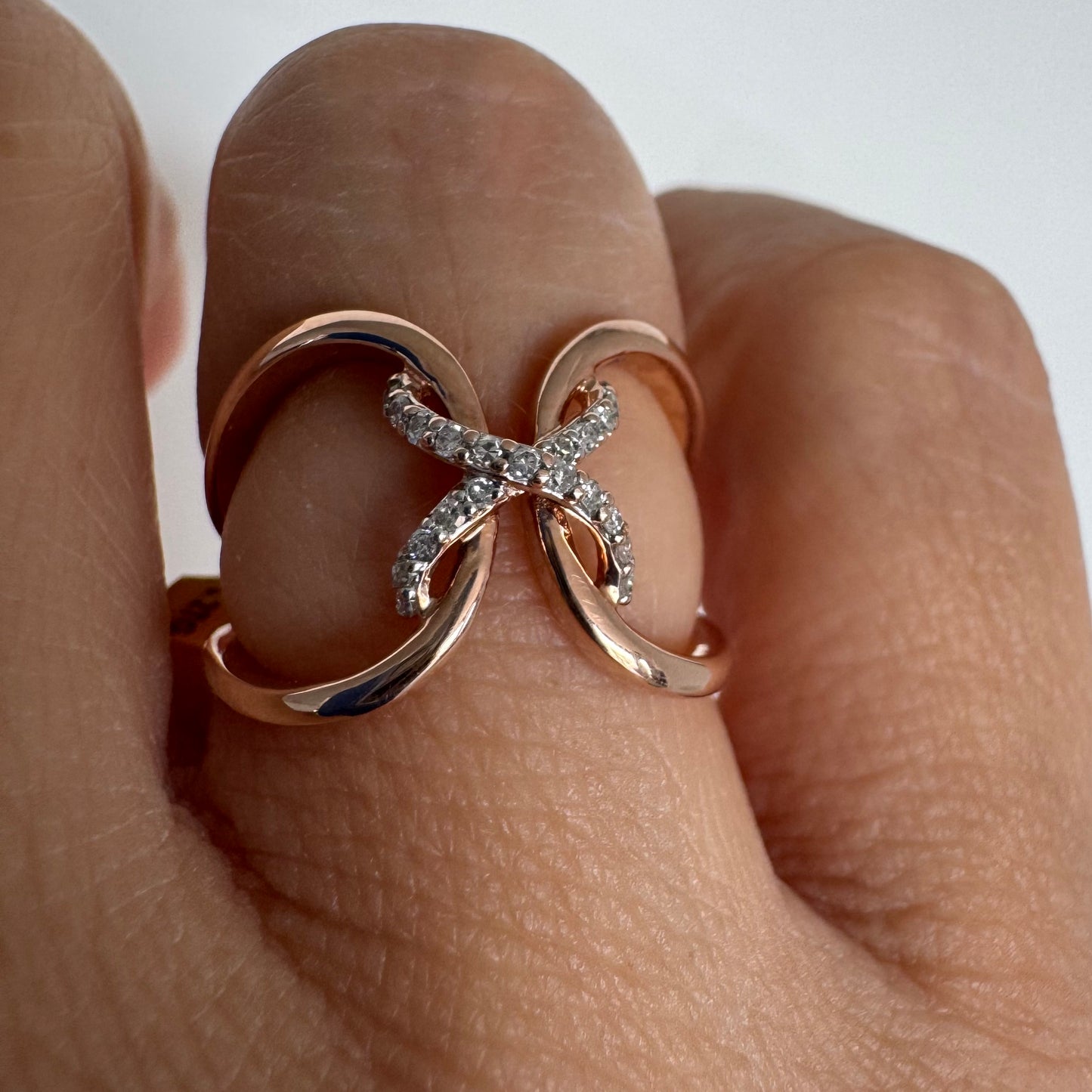 10K rose gold ring set with natural Diamonds in a flowing & artistic design.