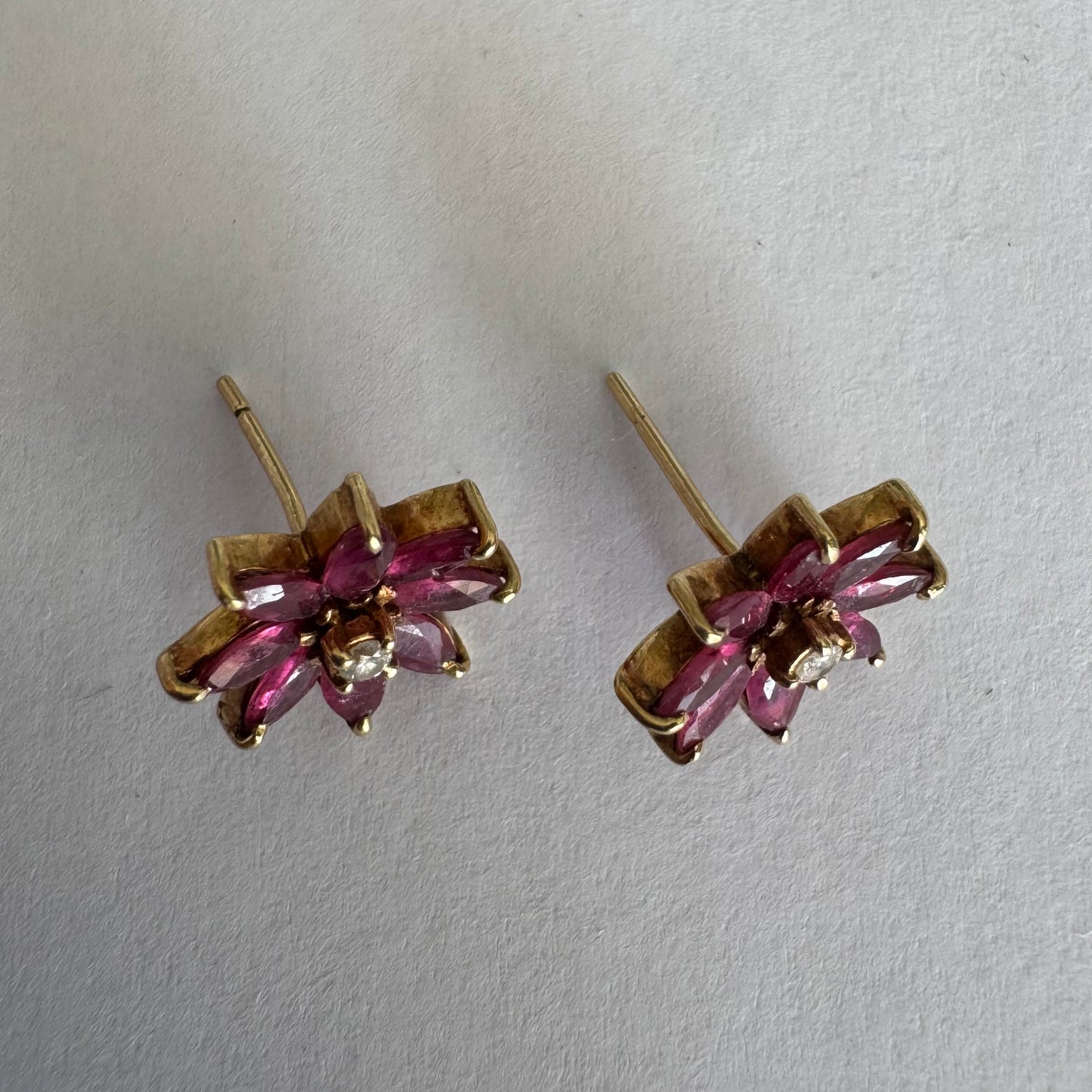 14K gold floral earrings set with marquise-cut Rubies and a small Diamond at the center