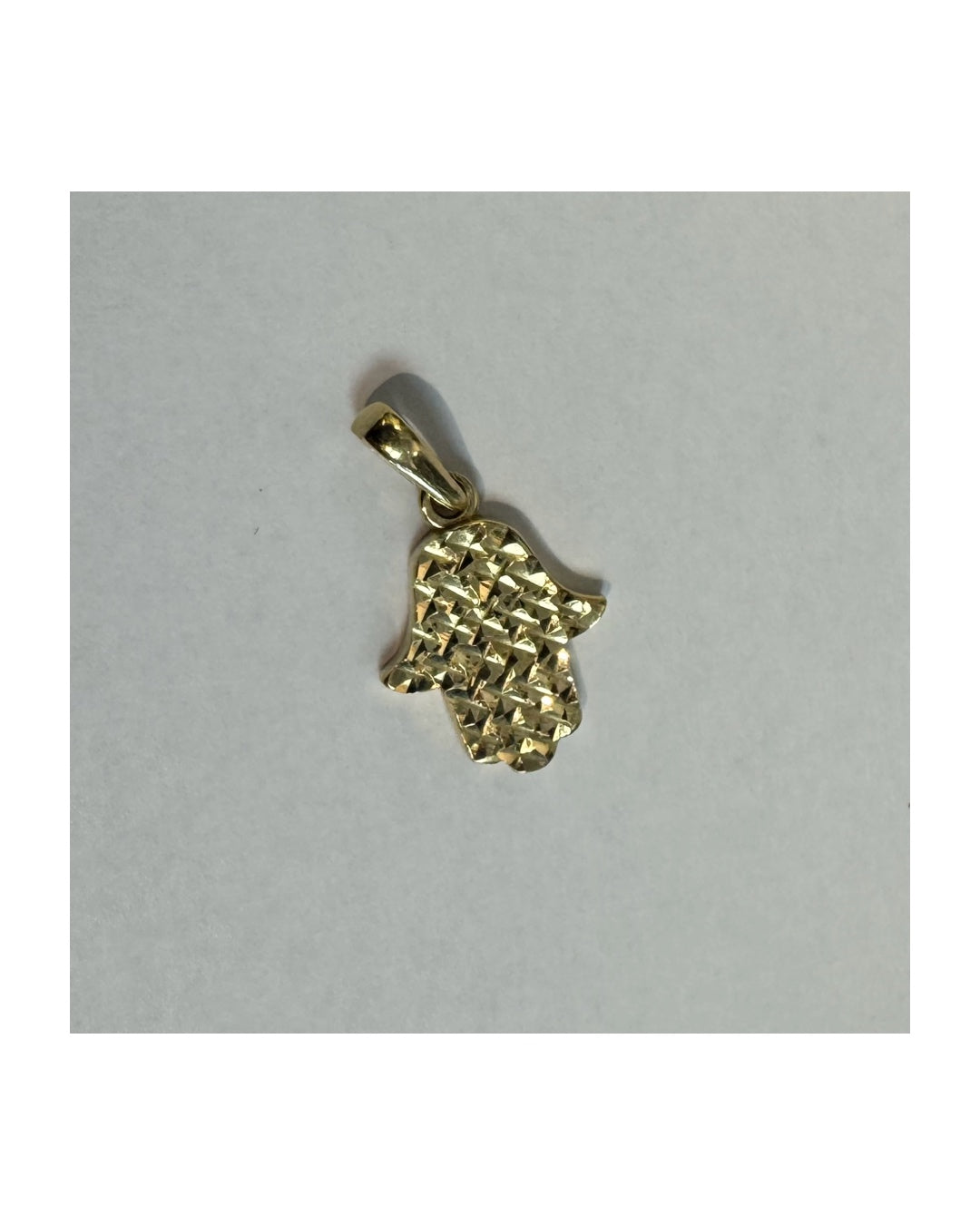 14K gold Hamsa pendant featuring a richly textured, light-catching finish.