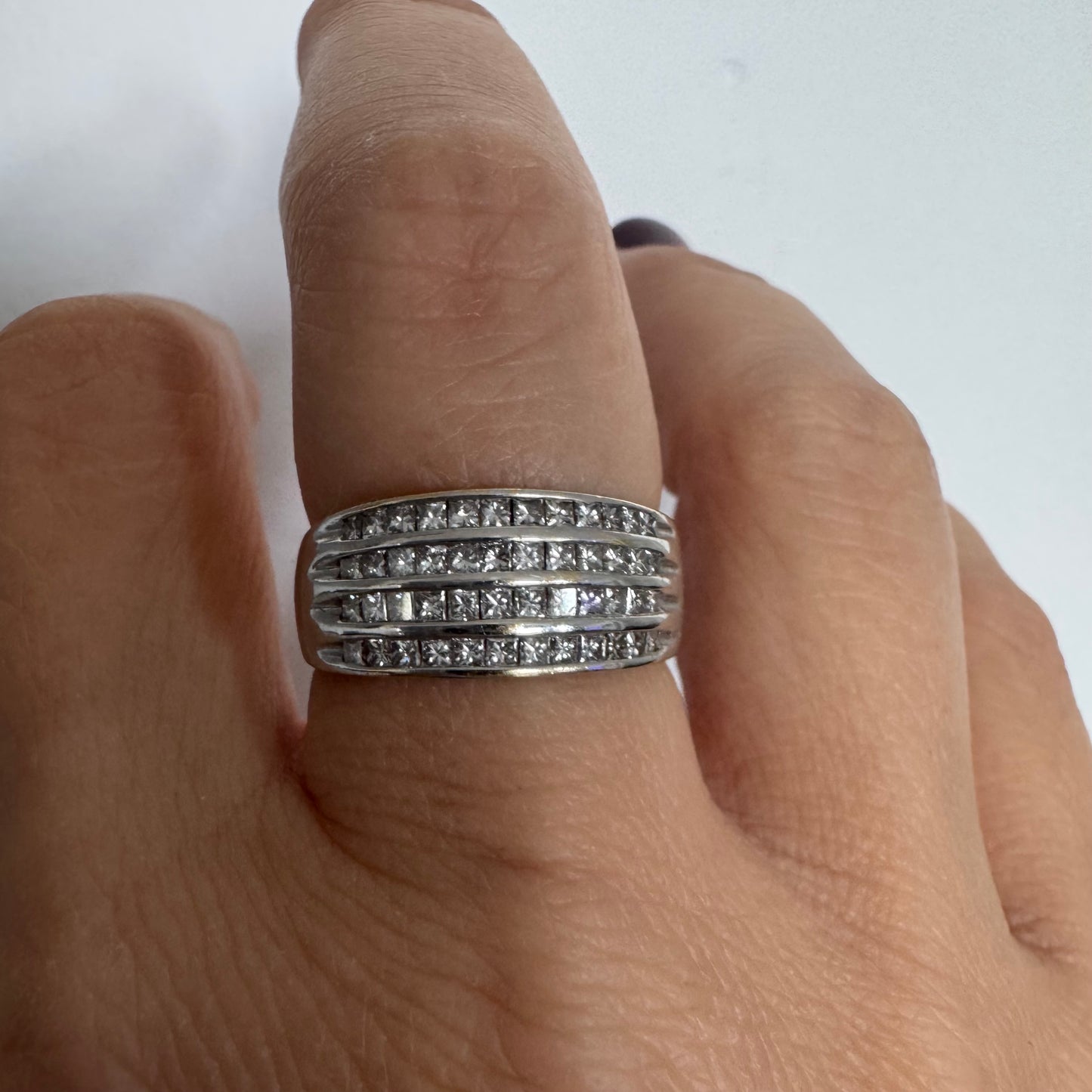 14K gold ring set with four parallel rows of princess-cut Diamonds.