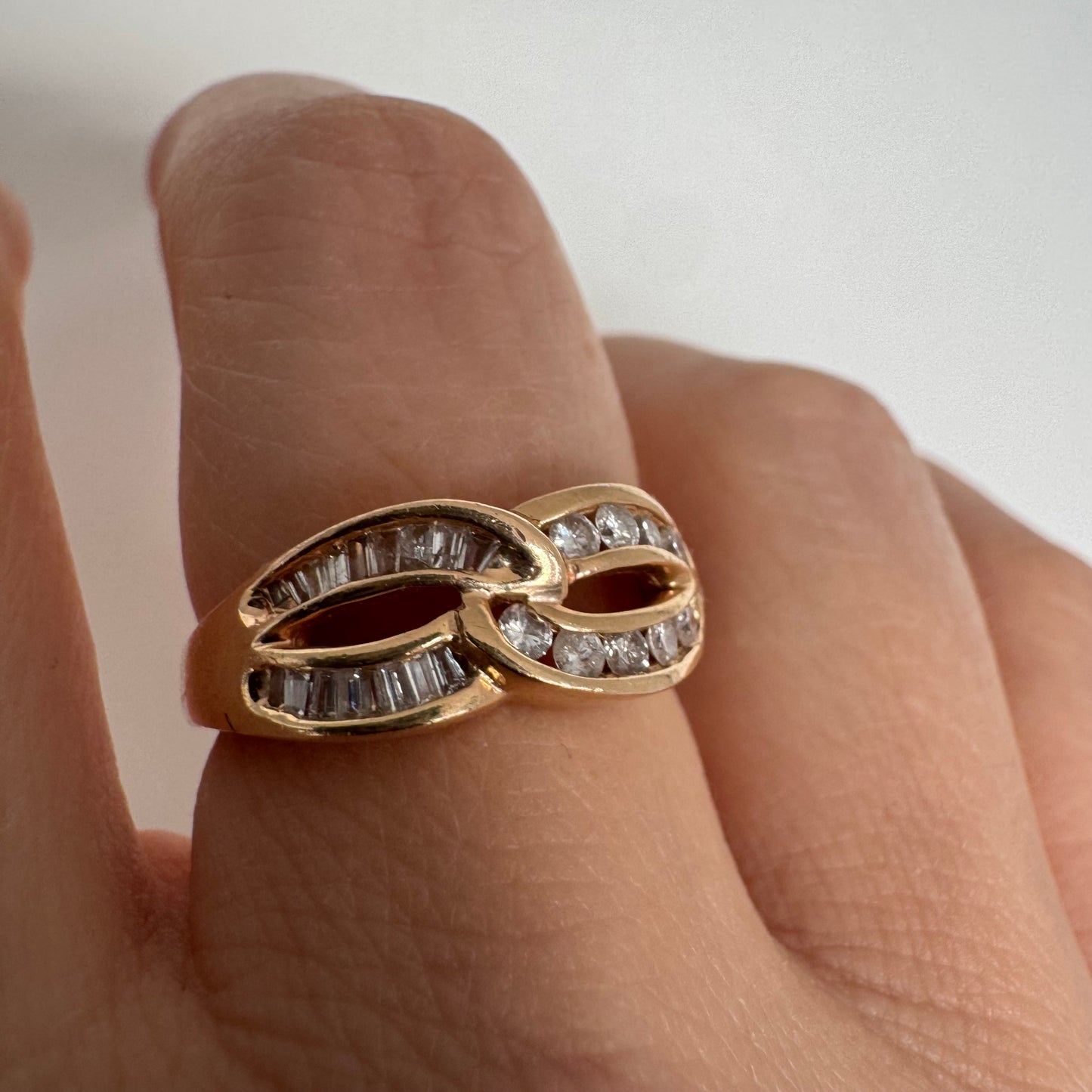 14K gold open infinity ring set with round and baguette-cut Diamonds.
