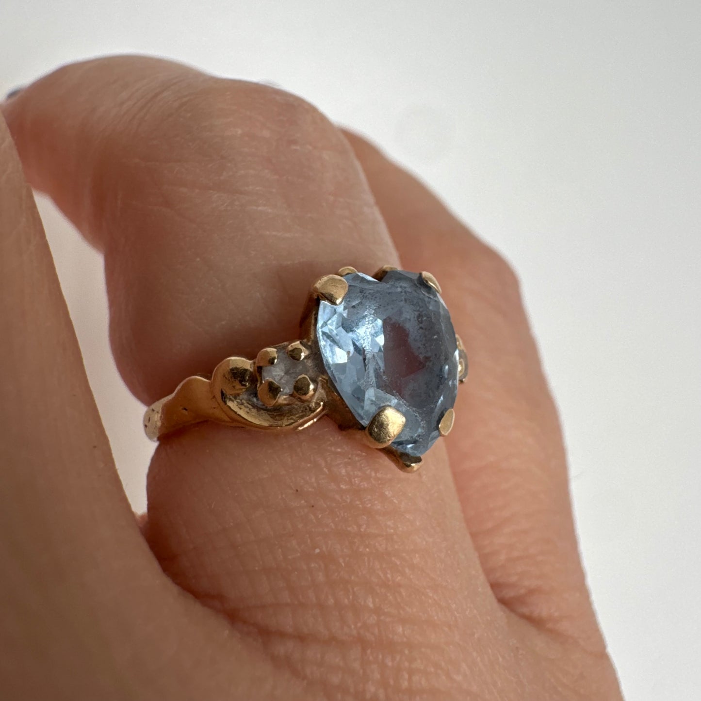 14K gold ring set with a heart-cut Blue Topaz stone