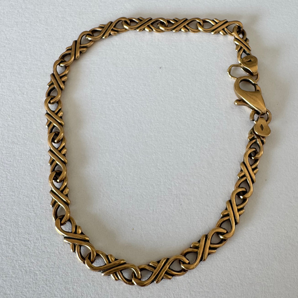 14K gold bracelet with a delicate twisted-link design.