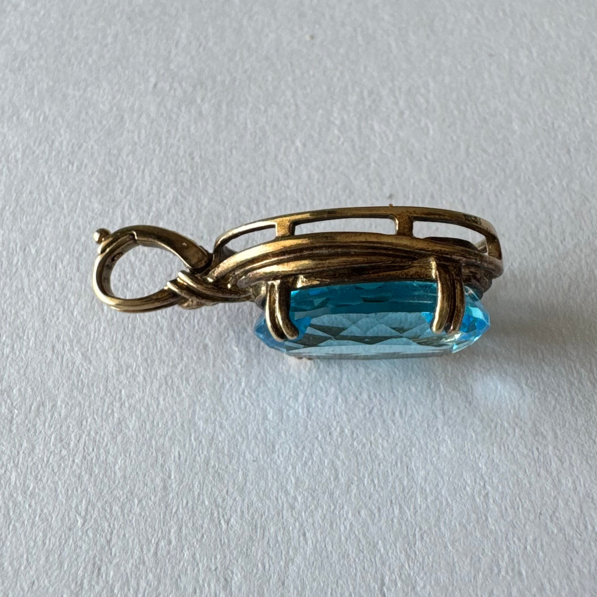 9K gold Pendant set with a striking oval-cut Blue Topaz