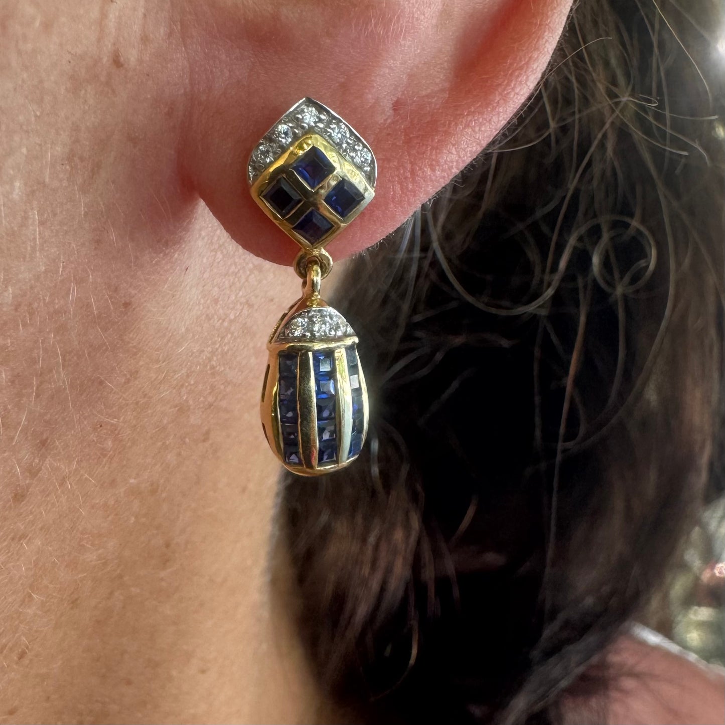 18K old drop earring set with deep blue Sapphires in a geometric pattern, accented with sparkling Diamonds.