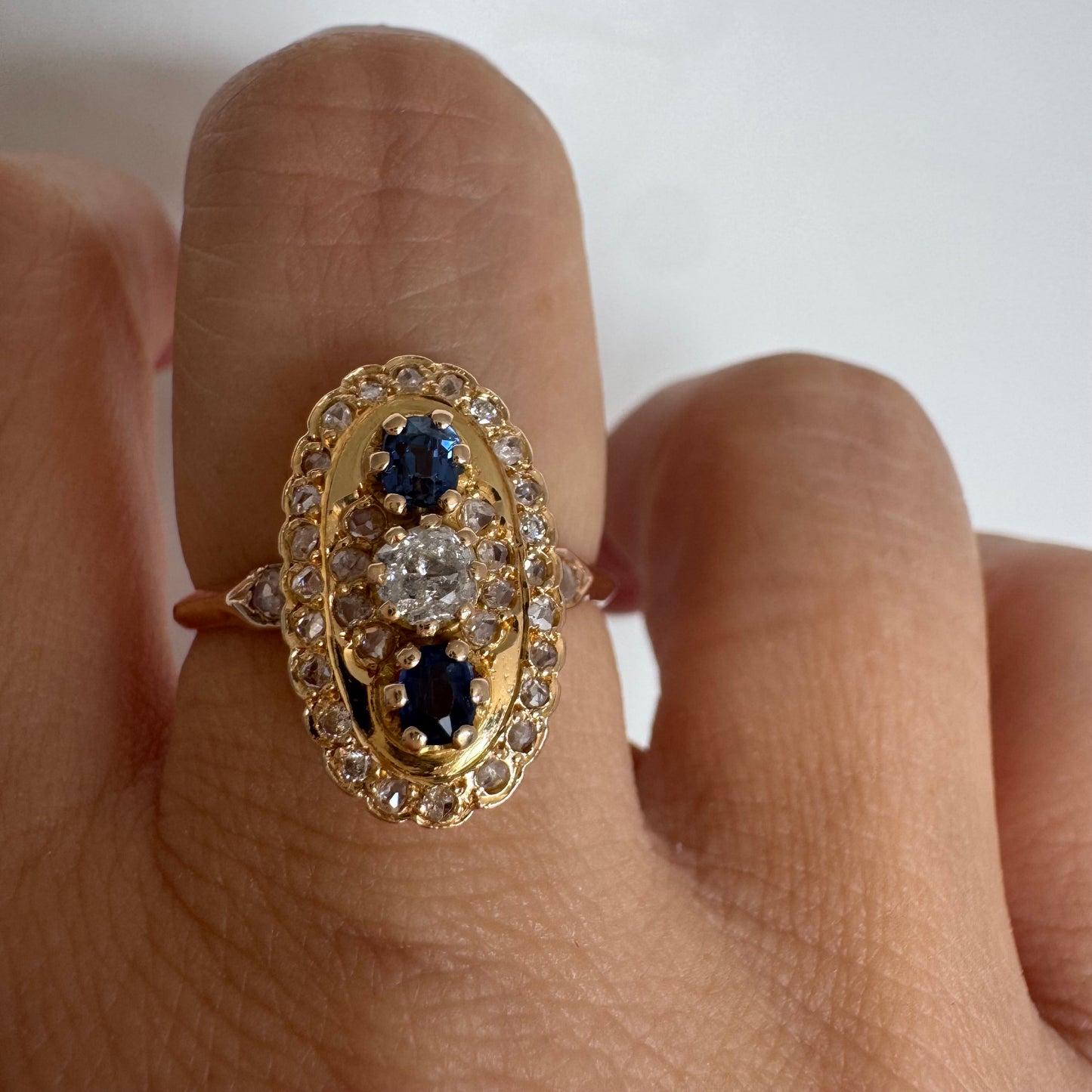 14K gold ring set with Diamonds and deep blue Sapphires in a classic oval design.