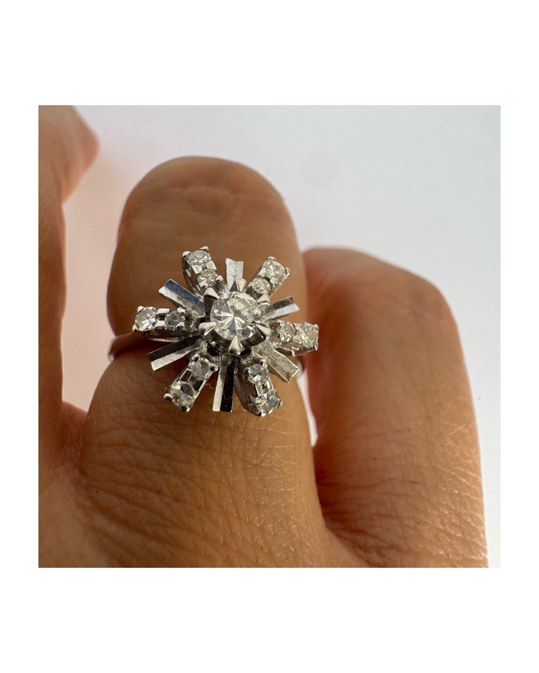 18K white gold ring designed as a radiant starburst, set with brilliant-cut diamonds that capture the light from every direction