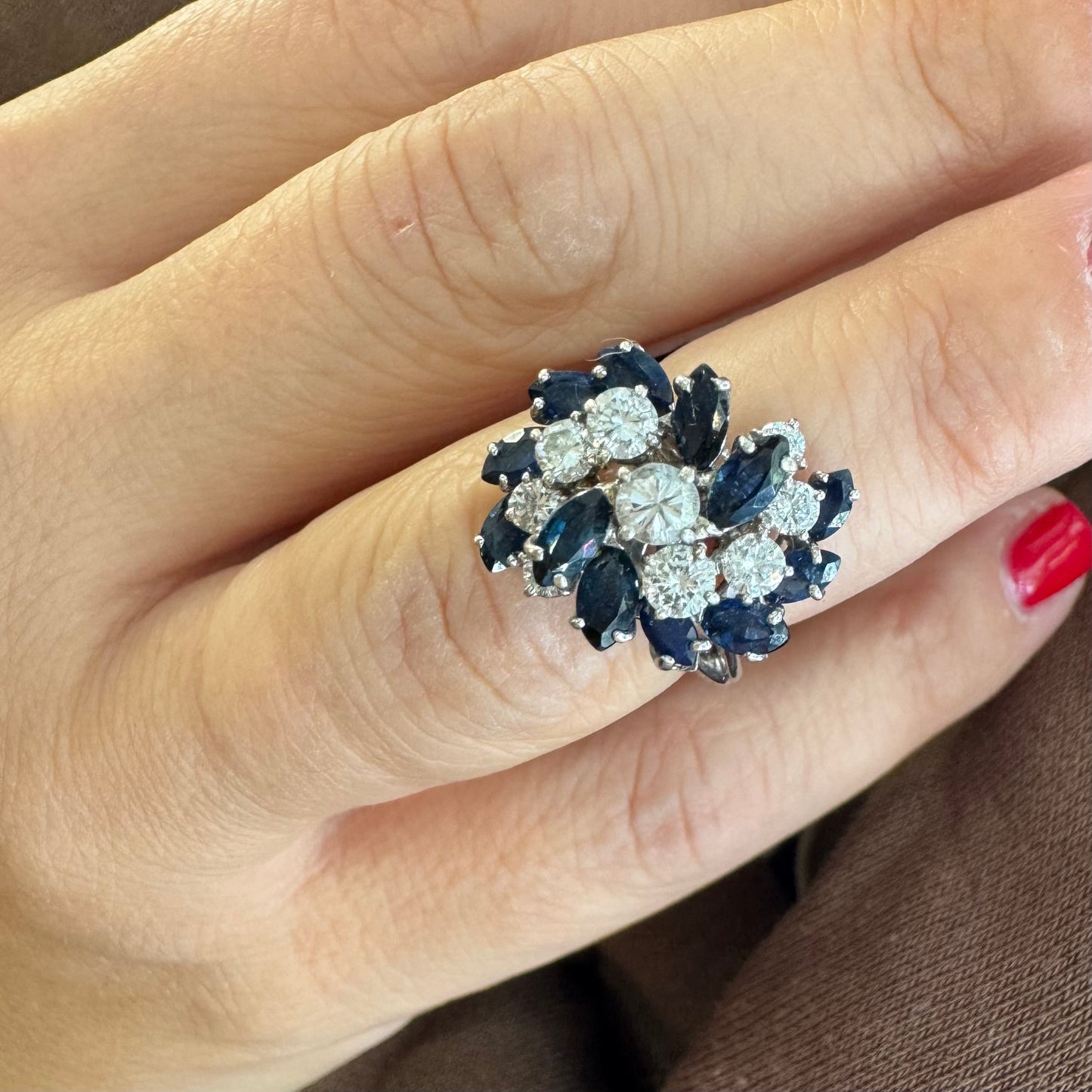 18K white gold ring, set with marquise-cut blue Sapphires and round Diamonds, in a classic cluster design.