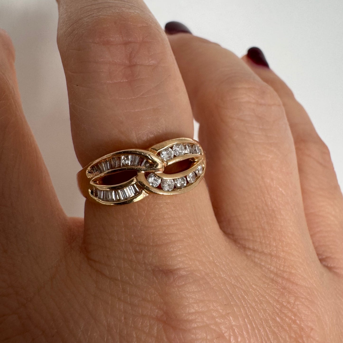 14K gold open infinity ring set with round and baguette-cut Diamonds.