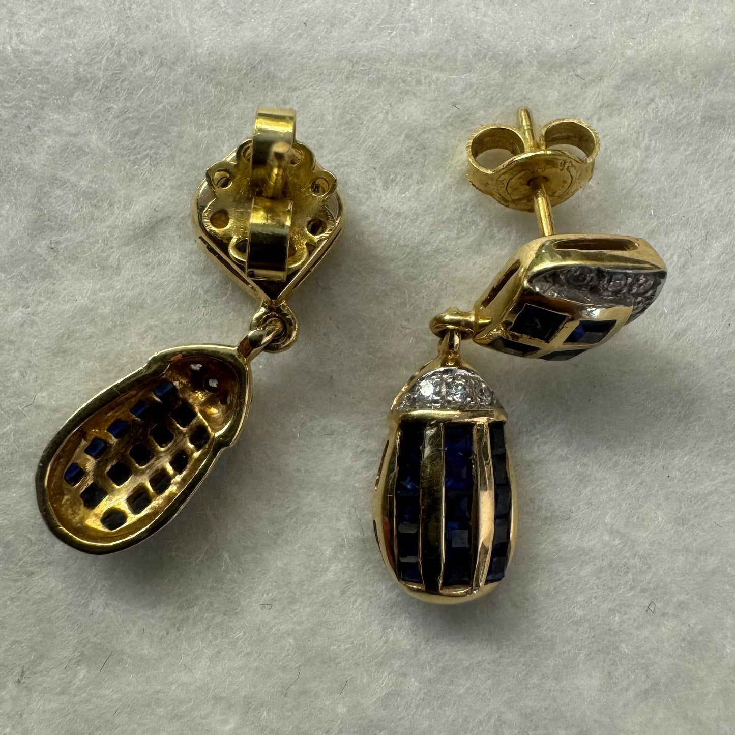 18K old drop earring set with deep blue Sapphires in a geometric pattern, accented with sparkling Diamonds.