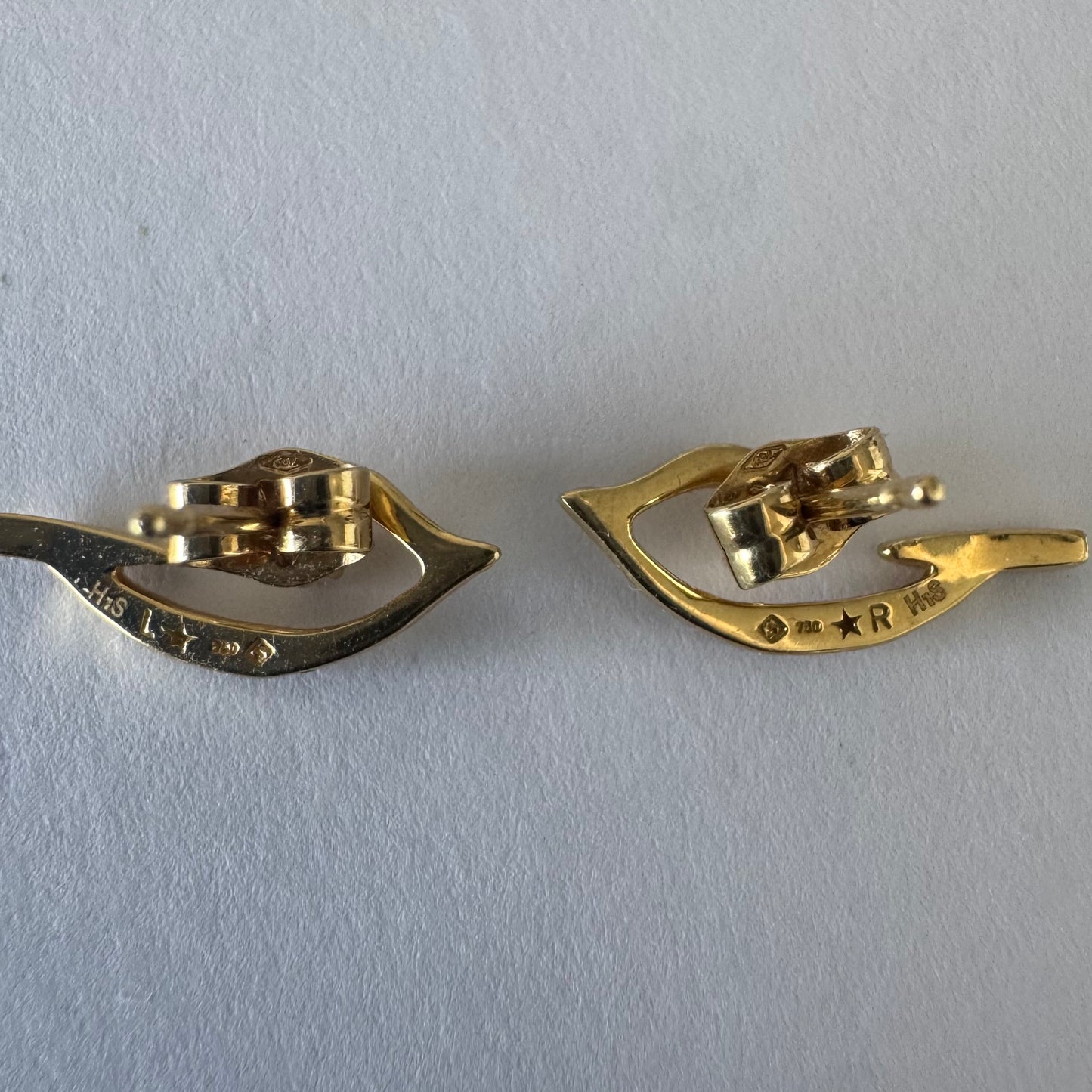 18K gold earrings in an abstract and elegant design featuring a unique handcrafted texture and a delicate Diamond set at the center