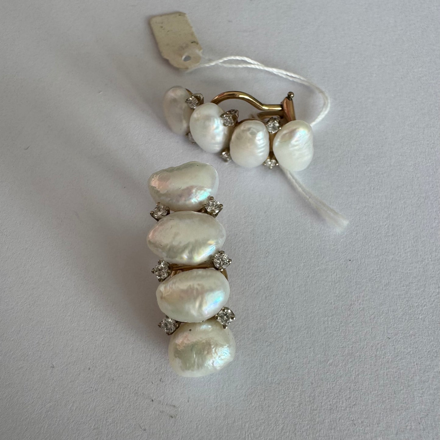 14K gold clip-on earrings set with Pearls accented by sparkling Diamonds between each pearl