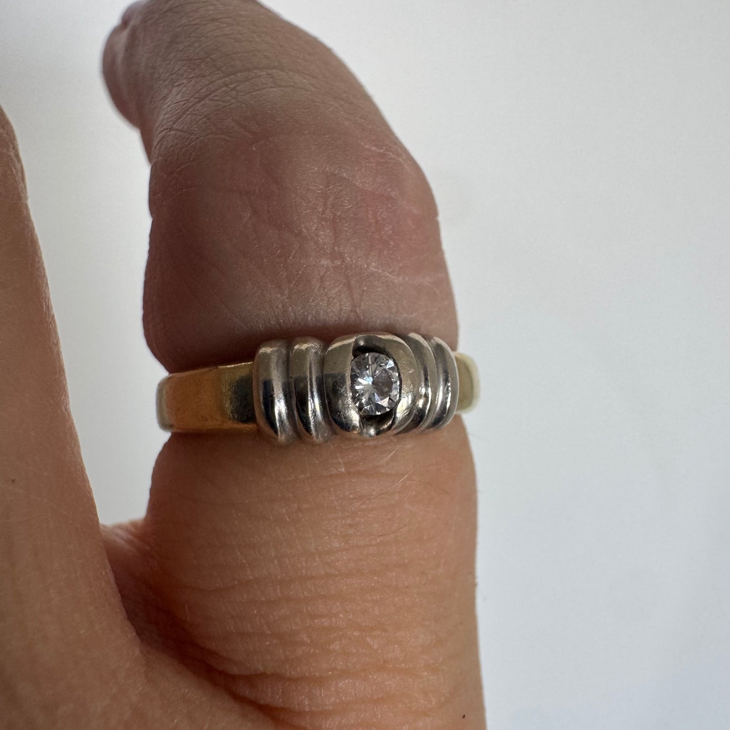 14K two-tone gold ring set with a central Diamond in a clean and refined design
