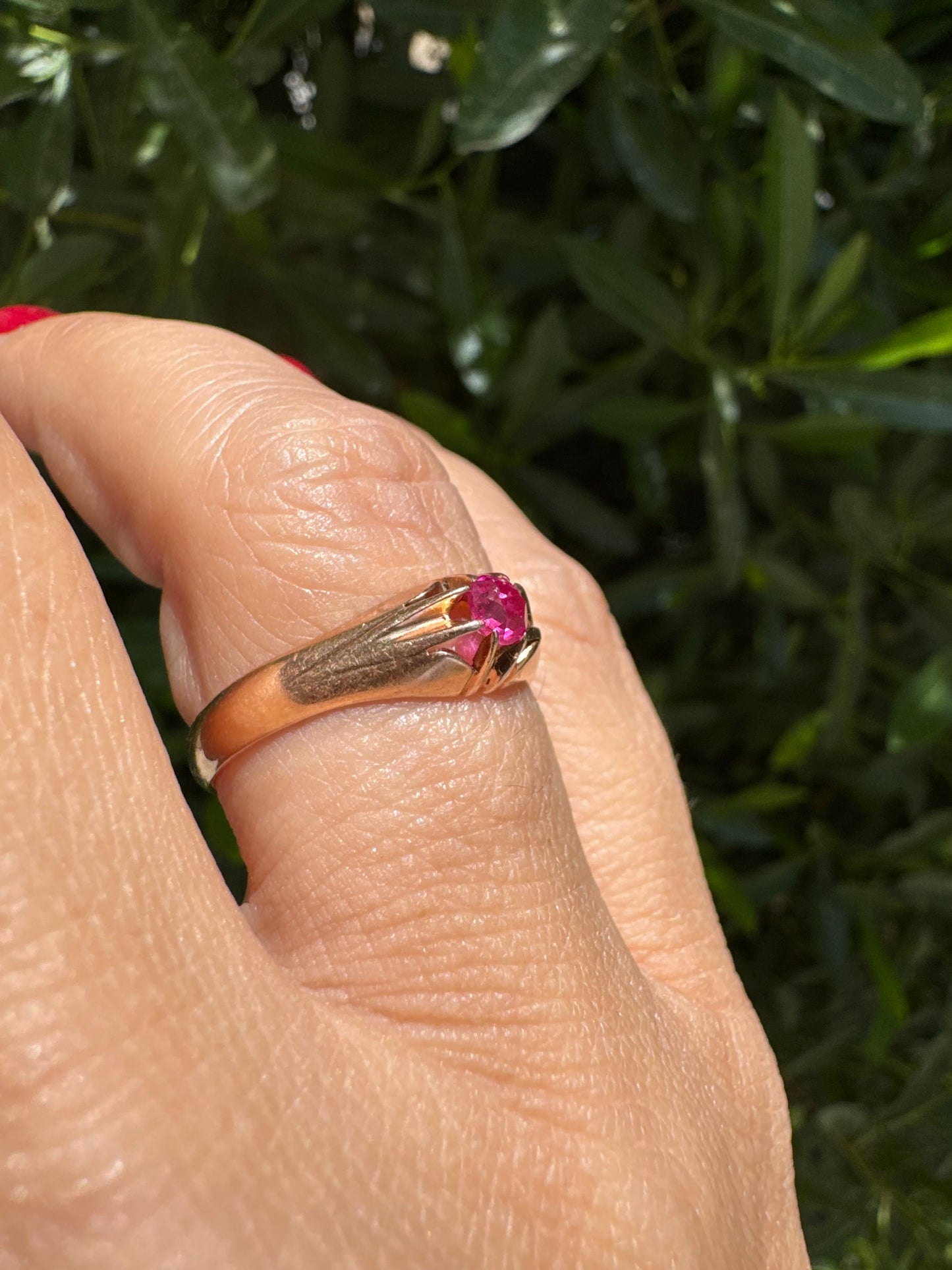 14K gold ring set with a vivid pink round-cut Ruby