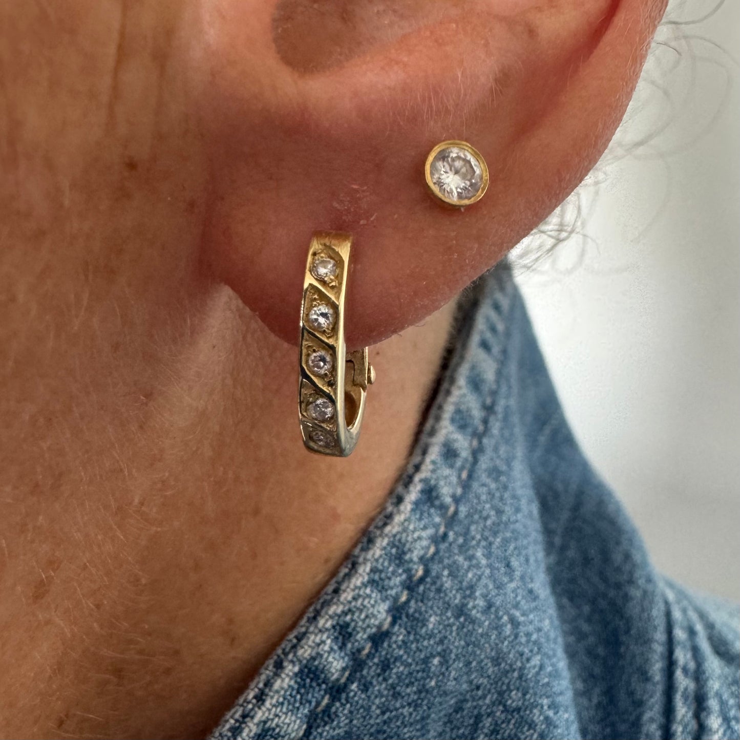 14K gold huggie earrings accented with a delicate row of sparkling Diamonds