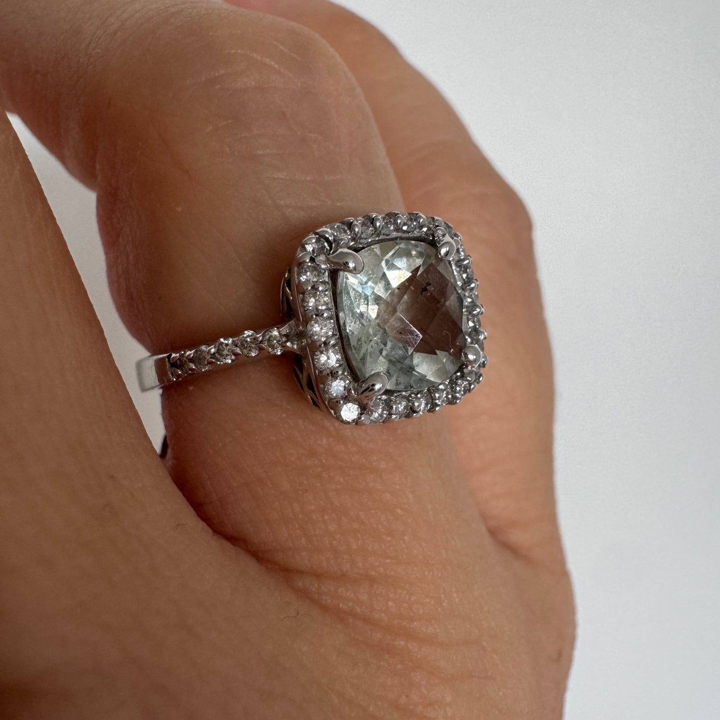 14K white gold ring featuring a cushion-cut light blue Aquamarine set in a sparkling double halo of round-cut Diamonds.