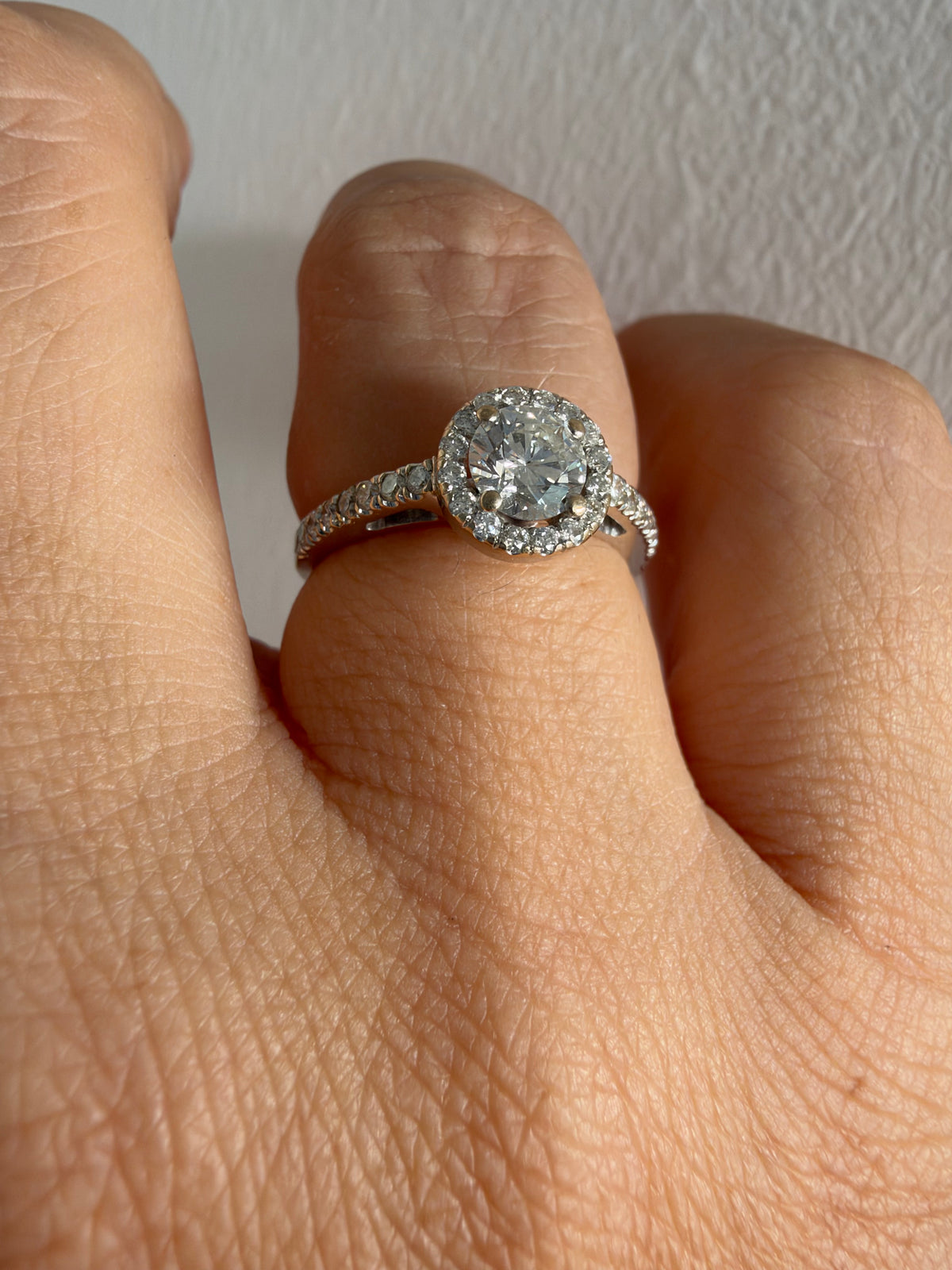 14K white gold vintage ring with a round brilliant-cut diamond and diamond halo