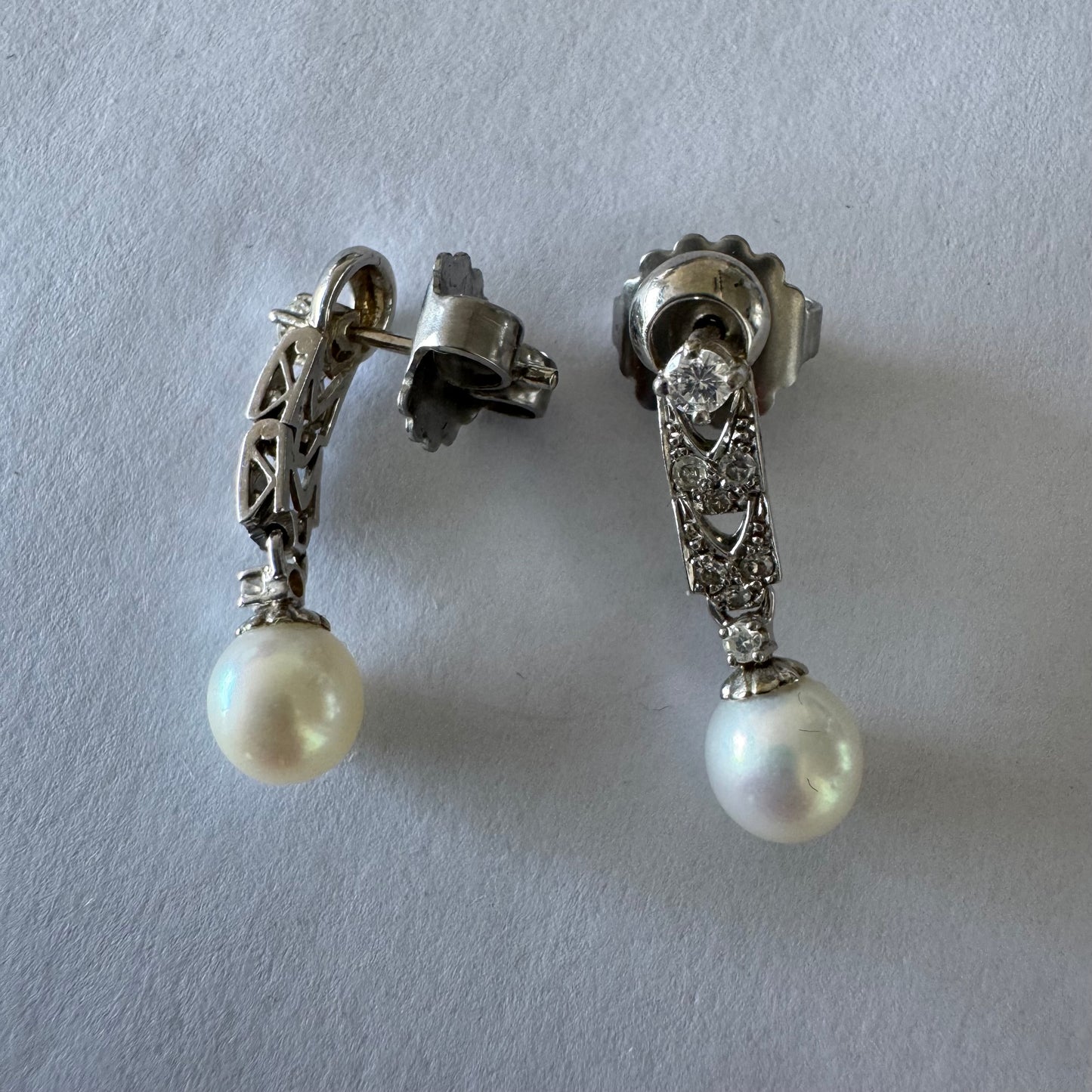 14K gold drop earrings set with Diamonds and a dangling Pearl.
